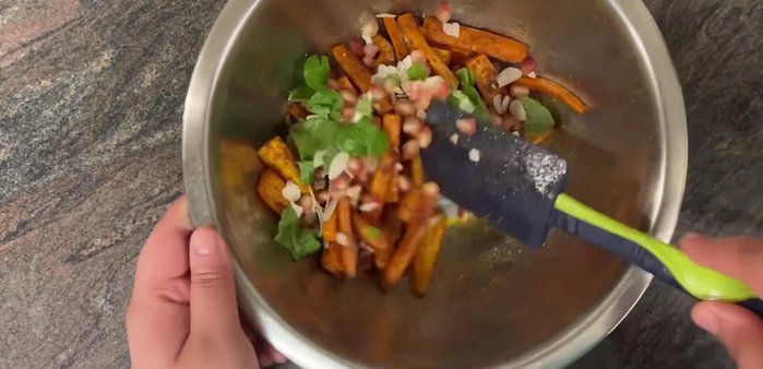 Place the carrots in a serving bowl, top with more almonds and mint, and crumble feta cheese over the top.