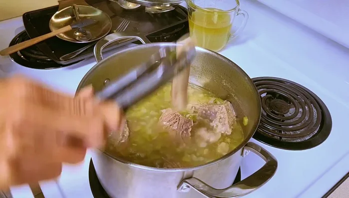 Remove short ribs from the pot and pull the meat from the bone.