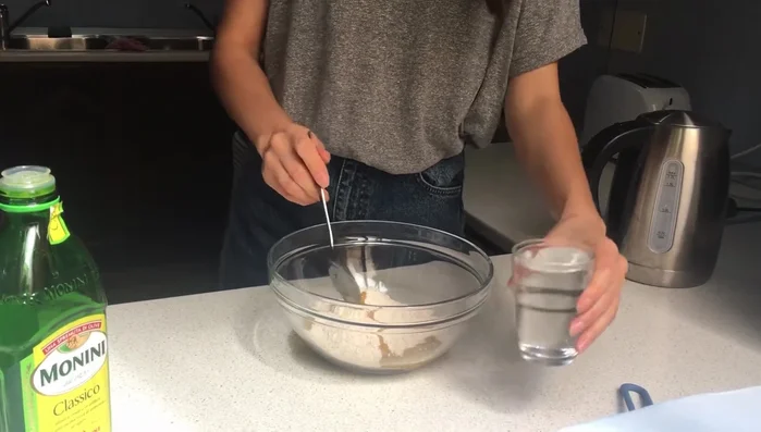 Slowly add hot boiling water to the flour mixture.