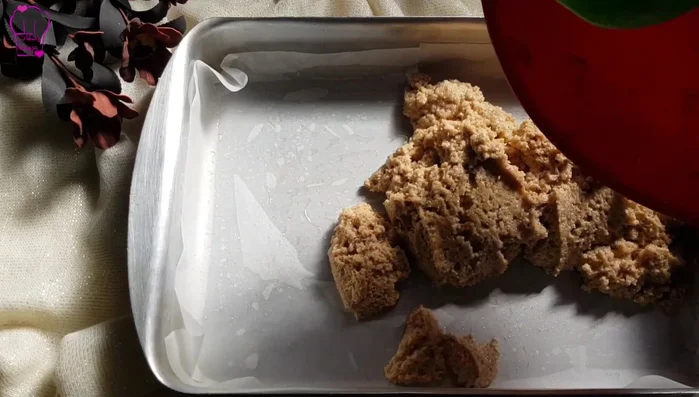 Grease a baking tray with oil and line it with butter paper (or just grease it with oil). Spread the dough evenly onto the tray using your hands. The dough won’t stick due to the oil.
