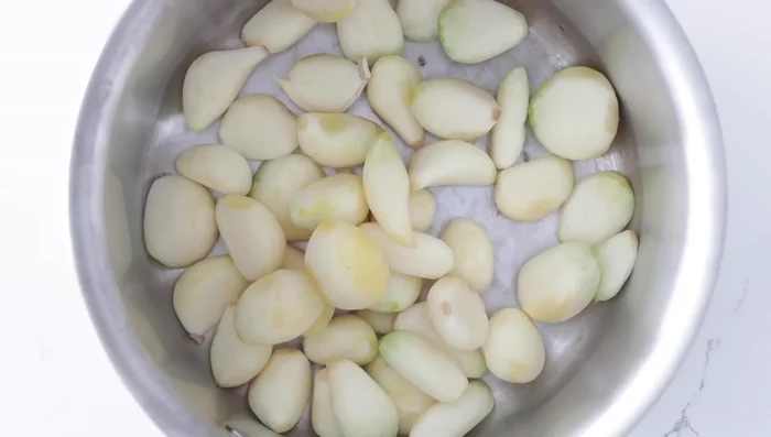 Prepare the roasted garlic: Add peeled and trimmed garlic to a small saucepan. Add extra virgin olive oil. Cook over medium-low heat for 45 minutes, until golden brown and roasted.