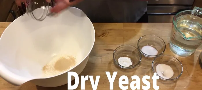Combine yeast, sugar, and salt in a bowl.