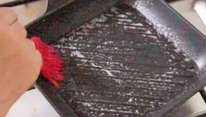 Lightly brush oil on the outside of the sandwich. (211.78)