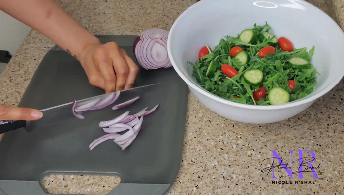 Prepare your salad: Wash and chop your chosen vegetables (arugula/mixed greens, tomatoes, red onions, cucumbers, bell pepper, sun-dried tomatoes). Add optional protein sources like edamame, chickpeas, or tofu.