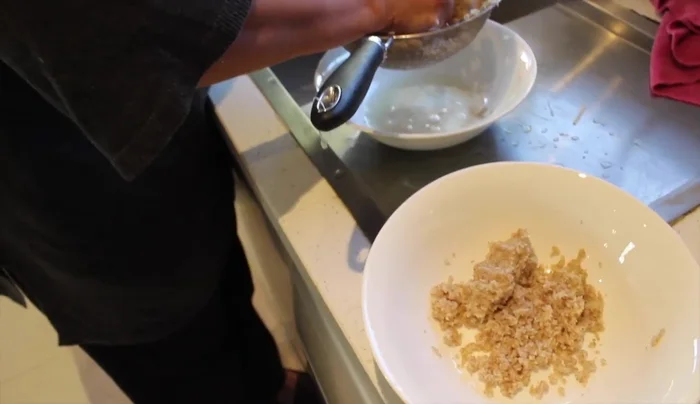 Strain the bulgur using a sieve and squeeze out excess water.