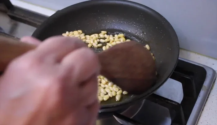 Shallow fry pine nuts until golden brown, drain on paper towels, and add to the chicken mixture.