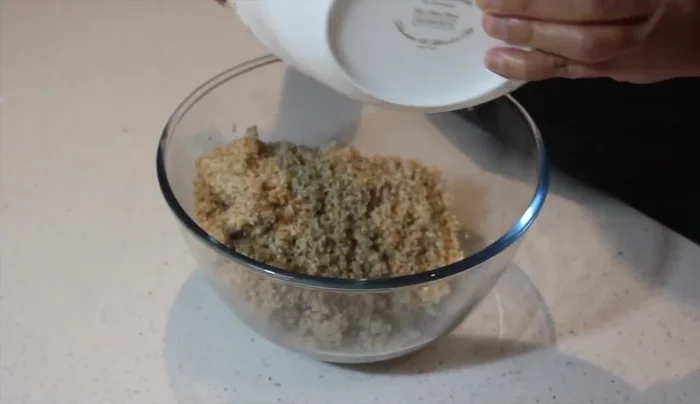 In a large bowl, combine the cooled chicken mixture, chicken breasts, reserved onion, lemon zest, and spices.