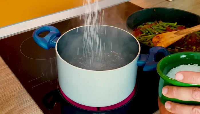 Boil 3 liters of water with 2 tbsp salt; cook rice al dente.