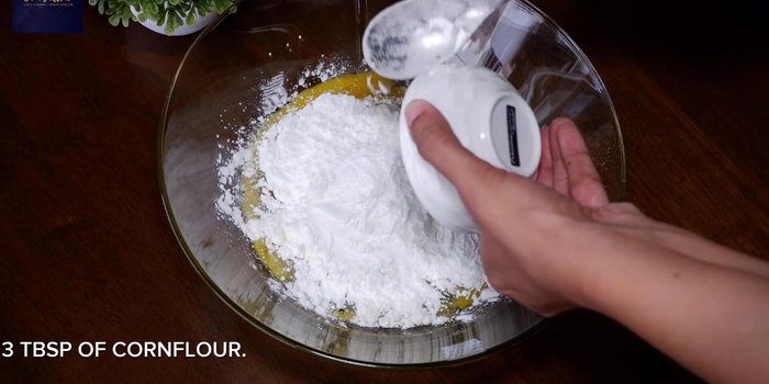 Add 4 tbsp maida, 3 tbsp corn flour, 2 tbsp ginger-garlic paste, 2 tbsp red chili powder, 3 finely chopped green chilies, 2 tsp garam masala, 1 tbsp cumin powder, 1 tsp roasted cumin powder, 1 tsp coriander powder, 1/2 tsp red food coloring, 2 tsp rice flour, juice of 2 limes, and salt to taste. Mix well.