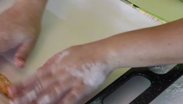 Place the dough rods onto a baking sheet lined with parchment paper. (160.239)