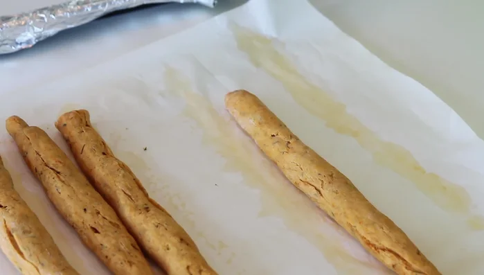 Once cool, use a sharp knife to cut the baked dough into small, diagonal pieces. (209.159)