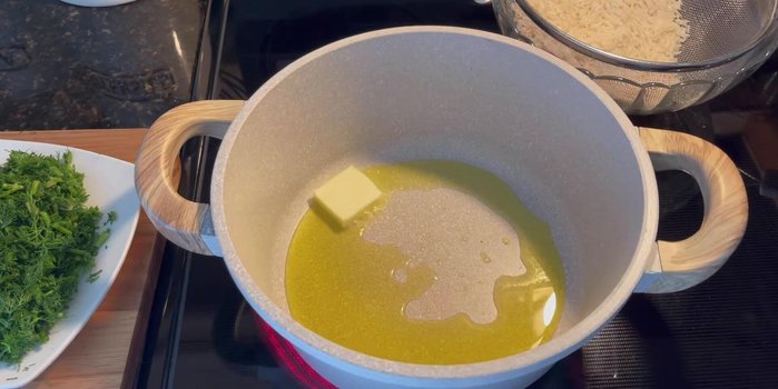 Add olive oil and 1 teaspoon of butter to a pan. Sauté dill and fava beans for a couple of minutes.