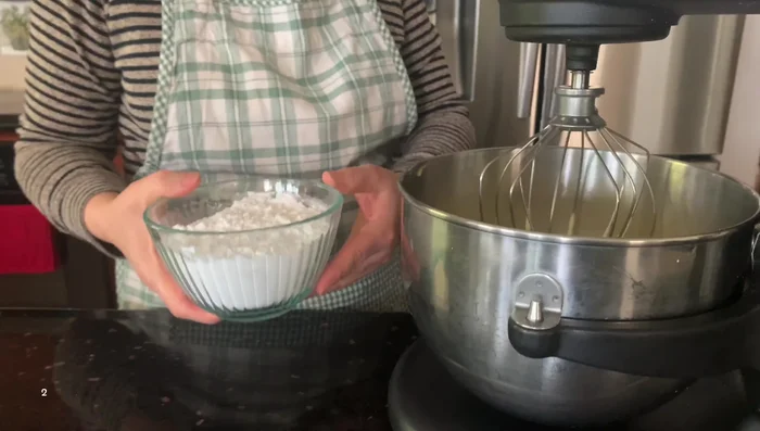 Combine powdered sugar, butter/ghee, and vanilla extract in a mixer. Start slowly, then increase speed.