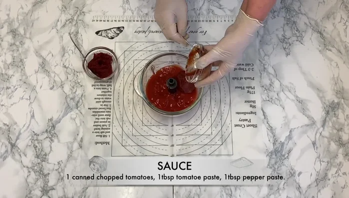 Prepare the sauce: Combine chopped tomatoes, tomato paste, and pepper paste. (66.4)
