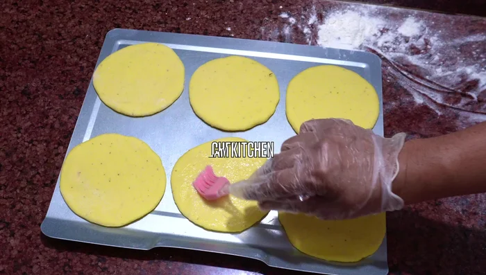 Brush the tops with egg wash. Sprinkle with sesame seeds (235.799-257.32).