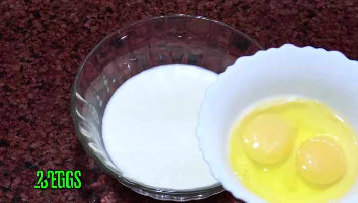 In a bowl, combine milk, eggs, salt, sugar, baking powder, dry yeast, cardamom powder, saffron, and food coloring. Mix well until everything is combined. (52-93.079)