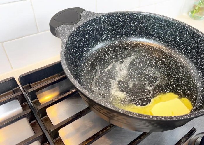 Brown the marinated chicken in a mixture of oil and butter over medium heat. Brown on both sides, remove, and set aside. Don't wash the pan.