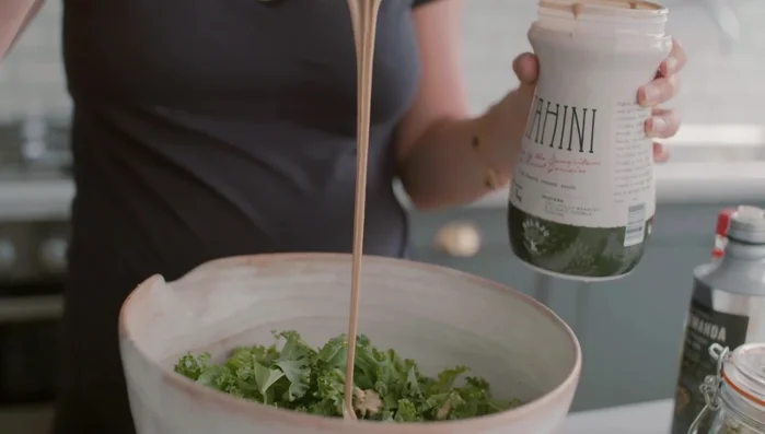 Massage kale: In a bowl, combine tahini, apple cider vinegar, tamari, lime juice, olive oil, and sea salt. Add kale and massage thoroughly for 3-4 minutes until leaves are softened.