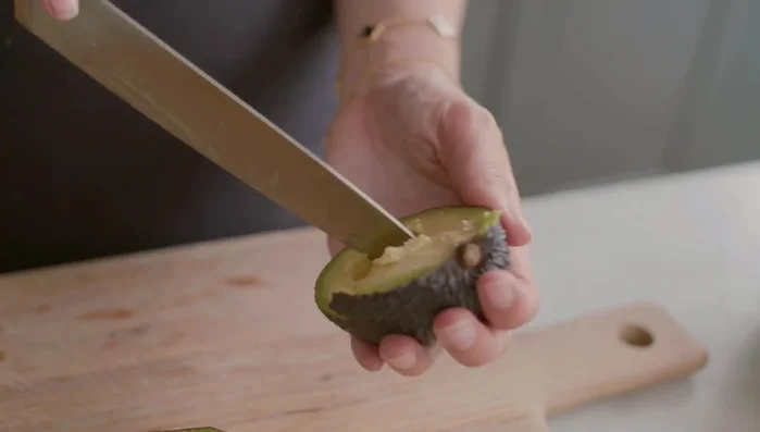 Assemble salad: Add avocado, pomegranate seeds, and sunflower seeds to the massaged kale.