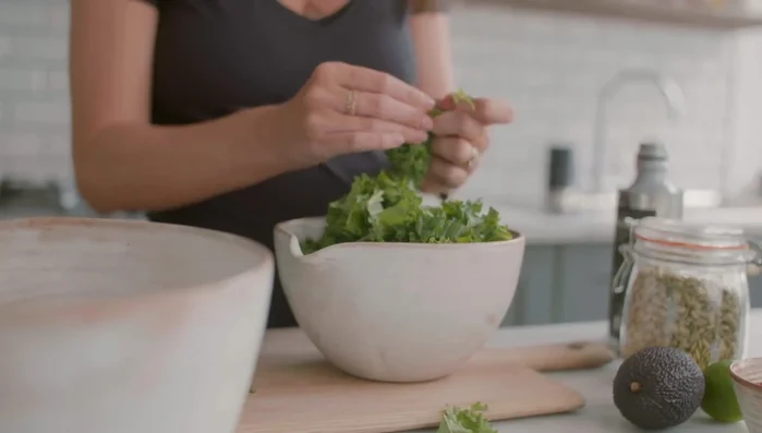Prepare kale: Remove hard stems from kale leaves.