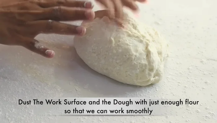 Divide the dough into two equal parts. Lightly flour the surface to prevent sticking. Shape each part into a tight dough ball, let them rest for 5 minutes.