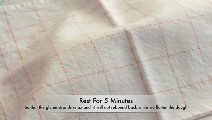 Flatten each dough ball into a 22cm diameter circle, about 1.5cm thick. Transfer to a baking tray lined with parchment paper and sprinkled with cornmeal or semolina flour.