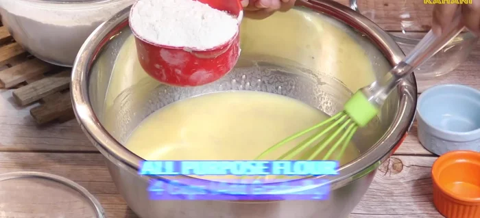 While mixing, add four cups of flour and make a soft dough.