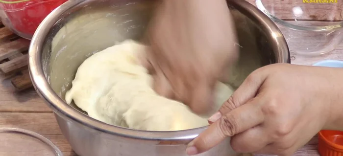 Oil your hands and apply it to the dough. Cover with cling wrap and let it double in size.