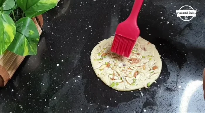 Final prep: Mix the reserved portion of the dough with 1 tbsp oil. Apply this mixture on top of each Sheermal for a nice color.