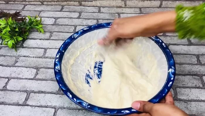 Prepare a simple syrup (sugar and water) and gently dip the luqaimat to coat them. (Specific quantities are missing in the transcript)