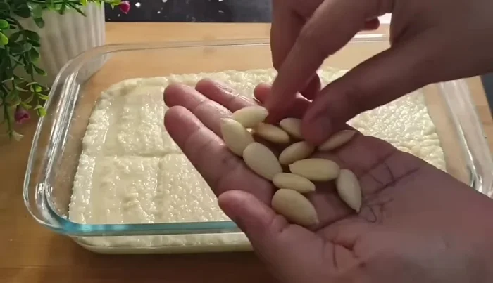 Arrange peeled almonds on top.