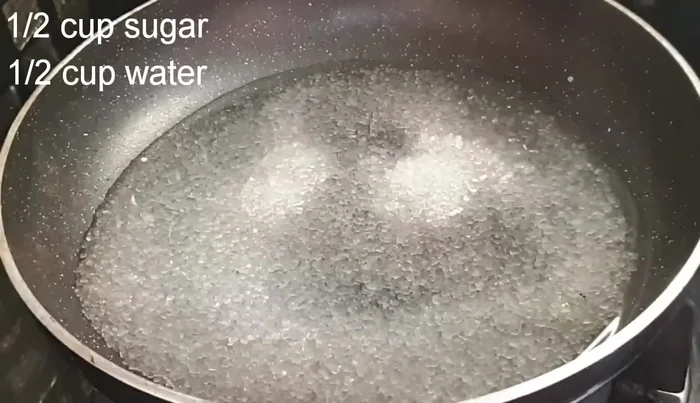 Prepare the sugar syrup (sheera): In a pan, combine sugar and water (and optional lemon slice, kewda water, rose water, or orange blossom water). Cook over medium heat until the sugar dissolves completely.