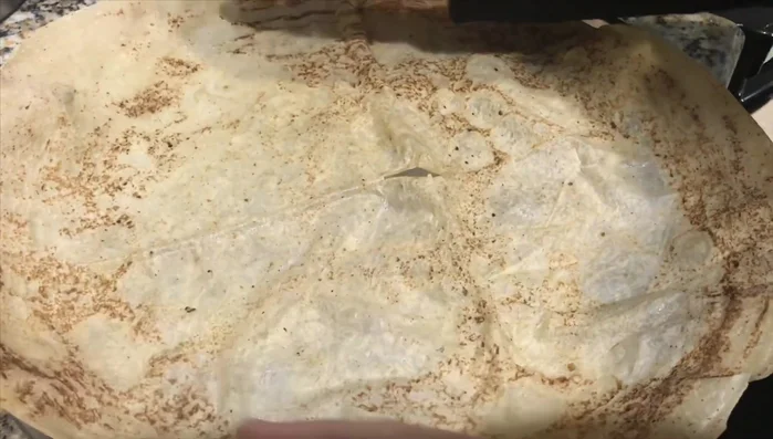 Assemble the Mansaf: Place flatbread on a tray, top with yogurt sauce, then rice, and finally the lamb meat. Garnish with fried almonds and parsley.