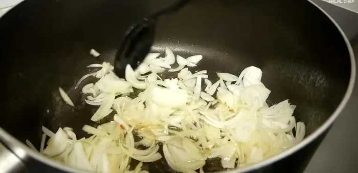 Remove chicken and add sliced onions to the pan. Cook until golden brown.
