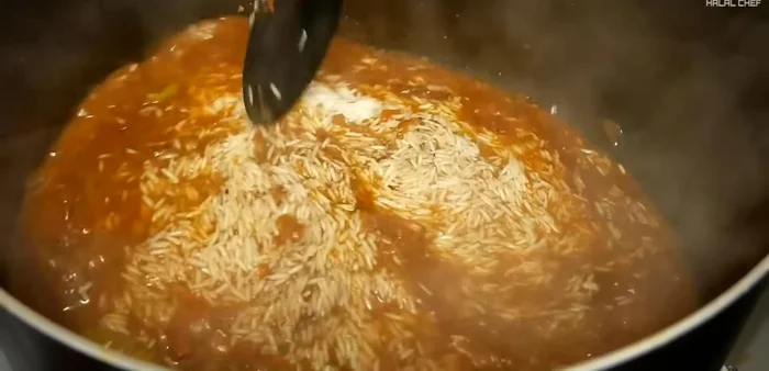 Add rice to the reserved cooking liquid. Simmer until some water remains.
