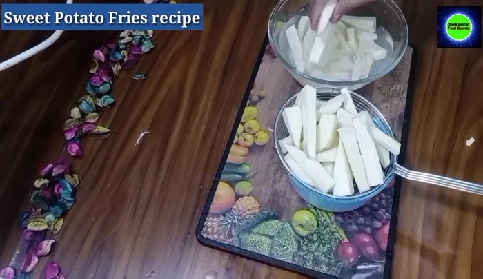 Place the cut sweet potato fries in a sieve and let them sit for 5 minutes to dry completely.