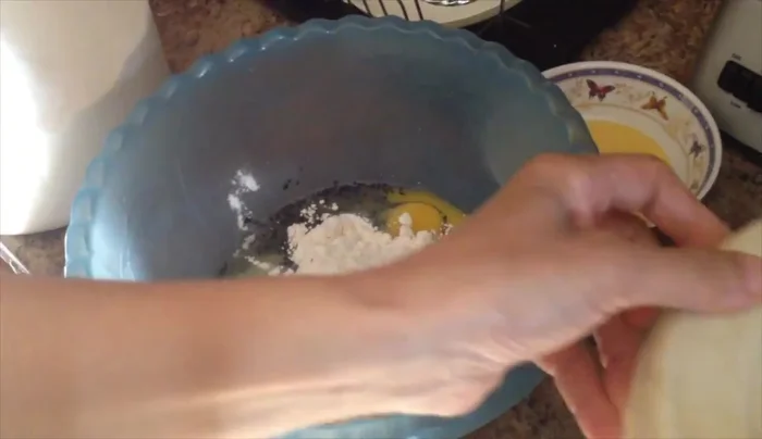Add 1 ½ cups Aunt Jamaa flour and 7 cups all-purpose flour to the egg mixture.