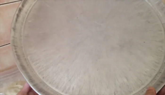 Oil an 18-inch pizza pan and lightly dust with flour.
