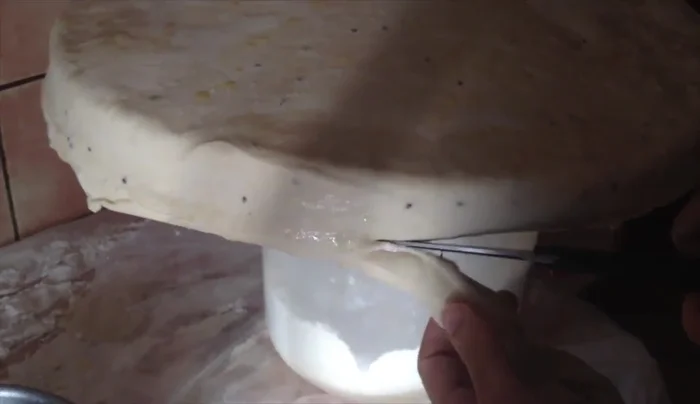 Cut off excess dough from the edges, leaving about 2 inches of overhang.