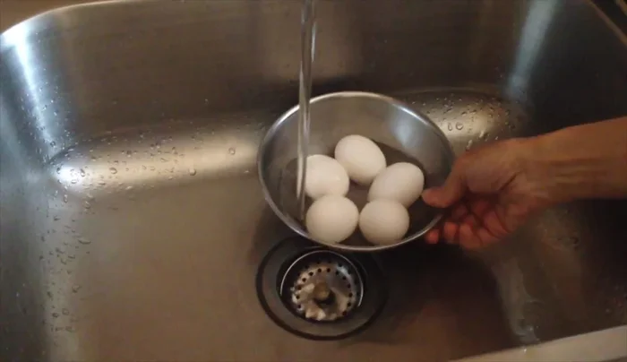 Warm 5 eggs in warm water.