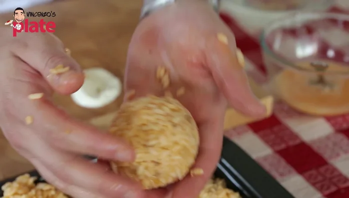 Shape the rice into a ball, ensuring your hands are wet to prevent sticking (291.479).
