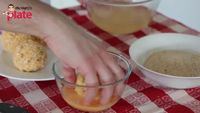 Dip the Arancini in beaten eggs, then coat with breadcrumbs (307.919).