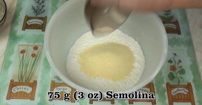 In a separate bowl, combine bread flour, semolina, salt, and crushed anise seeds.