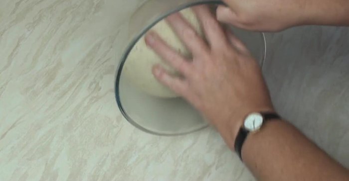 Once doubled, punch down the dough to release the gas.