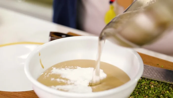 Whisk vigorously until the mixture thickens. Add chopped pistachios (for pistachio helva).