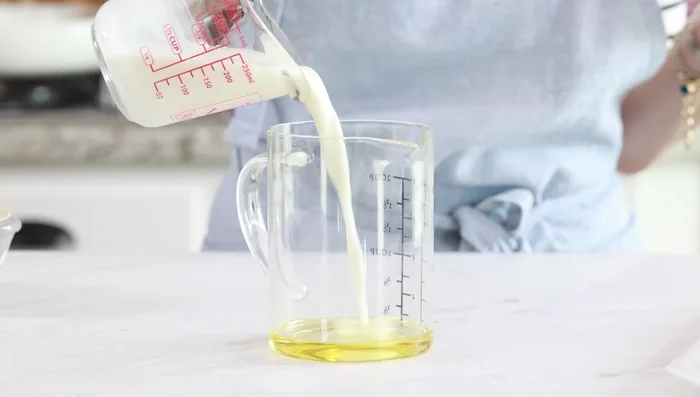 Make the egg wash: Whisk together 3 tbsp oil, milk, egg, yogurt, salt, and pepper (229.36).