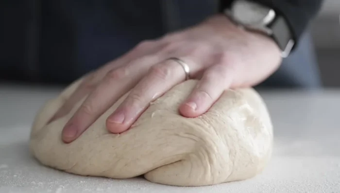 Shape and cut: Lightly flour a surface. Turn the dough out and gently press it into a rectangle. Use a bench knife to cut the dough into 12 equal pieces. (278.91)