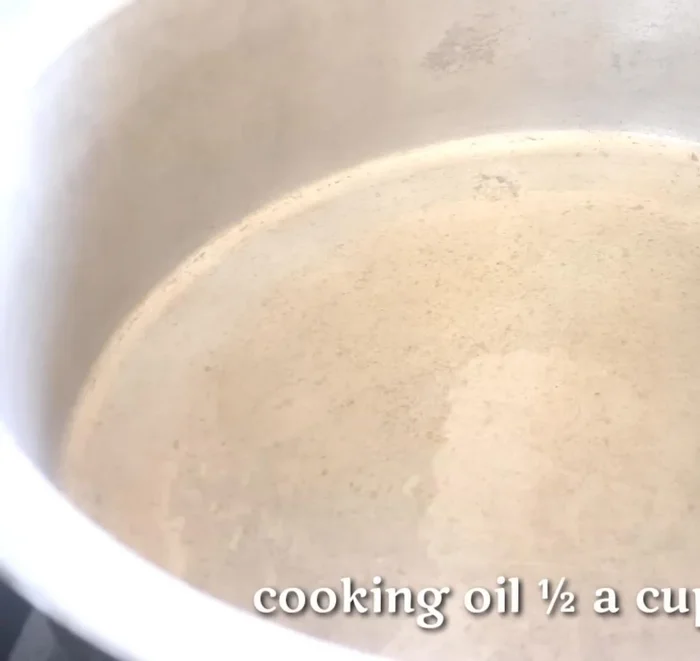 Prepare the rice: Chop 12 onions. Heat oil in a pan, sauté onions for 2 minutes, then add green chilies, 4K temple masala, salt, ghee, red chili powder, and turmeric powder. Add 1 liter of water, chicken stock cubes, and black lemons. Bring to a boil.