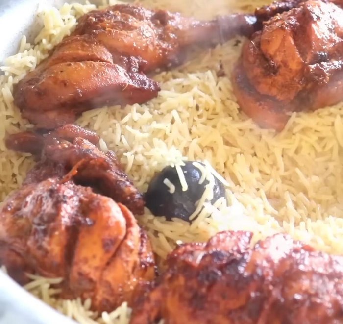 Assemble and smoke: Once the rice is cooked and the water has evaporated, arrange the fried chicken pieces on top. Heat coals and place them under the pot (or use a smoking method of your choice). Cover and let it smoke for about 10 minutes.
