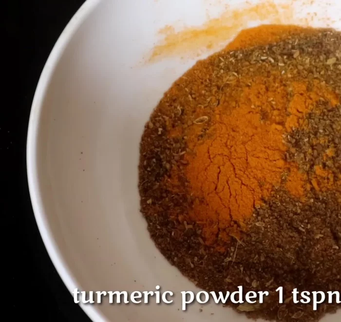 Marinate the chicken: In a bowl, mix Maggi masala powder, turmeric powder, salt, lemon juice, red chili powder, red food color (optional), olive oil (optional), and ginger-garlic paste. Apply this mixture thoroughly to the chicken, including the inside of the cuts. Marinate for at least 2-3 hours, or overnight for best results.